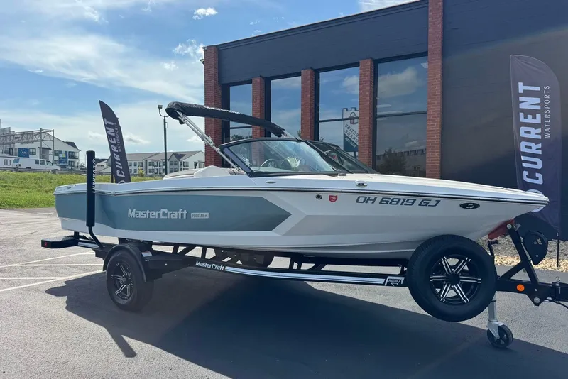 The Image of 2023 MasterCraft ProStar boat on trailer outside dealership. - 0