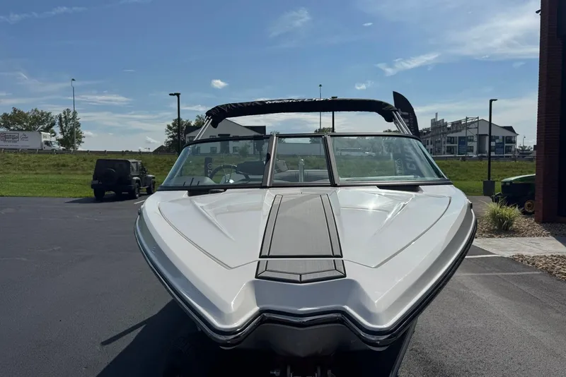 Slide: The Image of 2023 MasterCraft ProStar boat parked outdoors on a sunny day. - 4
