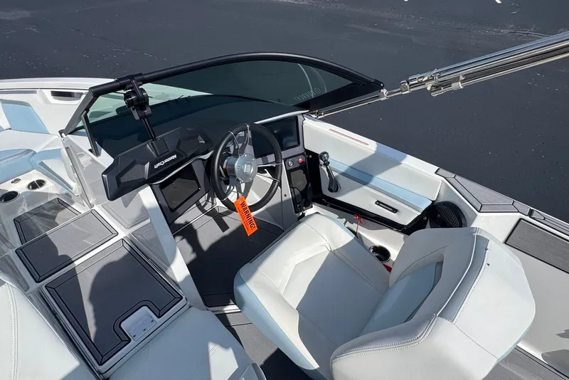 Slide: The Image of 2023 MasterCraft ProStar boat interior with steering wheel and seating. - 10