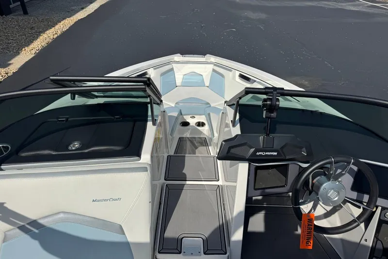 Slide: The Image of 2023 MasterCraft ProStar boat interior with sleek design and modern steering console. - 13