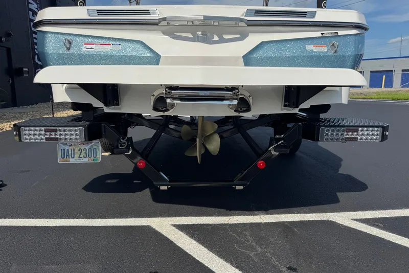 Slide: The Image of Rear view of a 2023 MasterCraft ProStar boat on a trailer in a parking lot. - 3