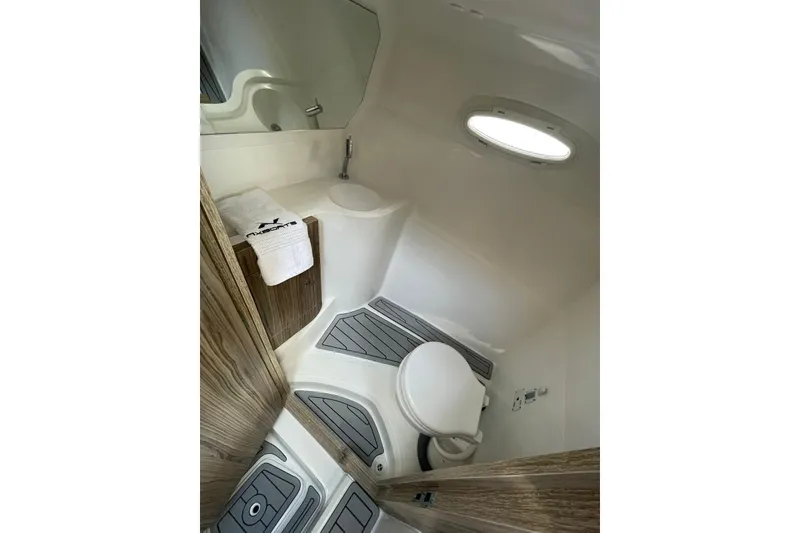 Slide: The Image of 2024 NX Boats NX280 XTREME bathroom with modern fixtures and wooden accents. - 8