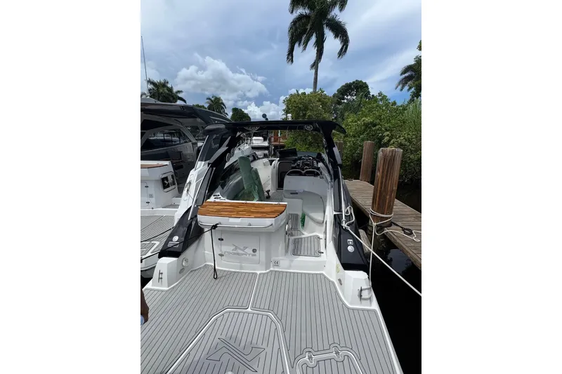 Slide: The Image of 2024 NX Boats NX280 XTREME docked, showcasing sleek design and spacious deck. - 3