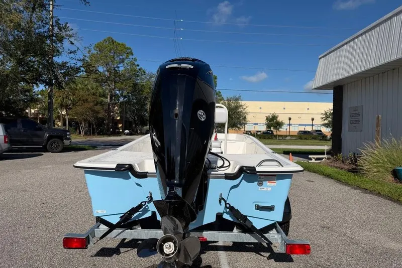 Slide: The Image of 2027 Mako Pro Skiff 17 CC boat on trailer, parked outdoors. - 3
