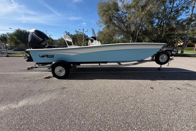 The Image of 2027 Mako Pro Skiff 17 CC boat on trailer, parked outdoors under clear sky. - 0