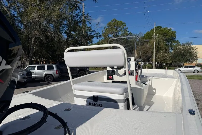 Slide: The Image of 2027 Mako Pro Skiff 17 CC boat with center console and Igloo cooler on deck. - 8