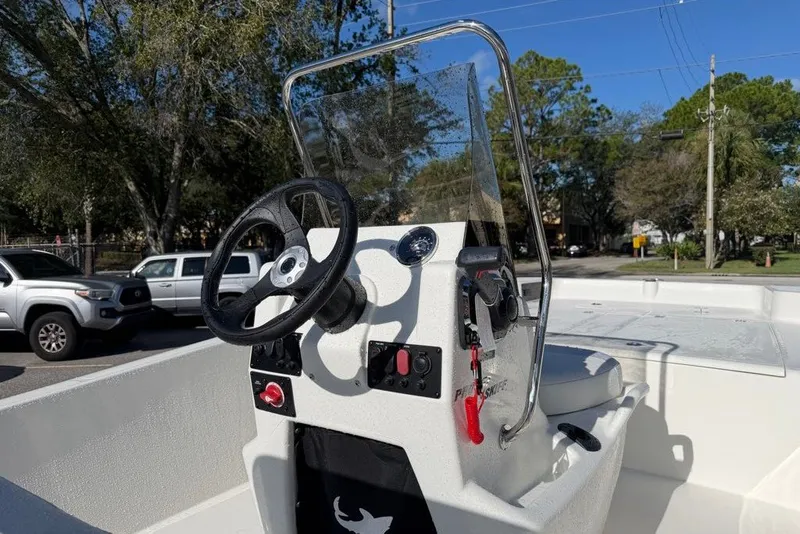 Slide: The Image of 2027 Mako Pro Skiff 17 CC boat console with steering wheel and controls. - 6