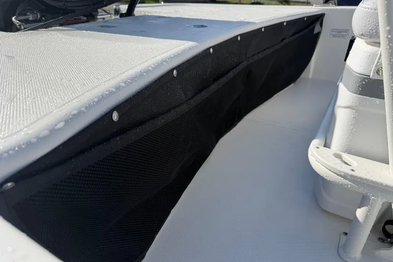 Slide: The Image of 2027 Mako Pro Skiff 17 CC interior with storage compartments and seating. - 55