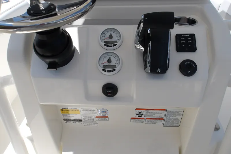 Slide: The Image of Center console controls of a 2027 Mako 226 boat, featuring gauges and throttle. - 18