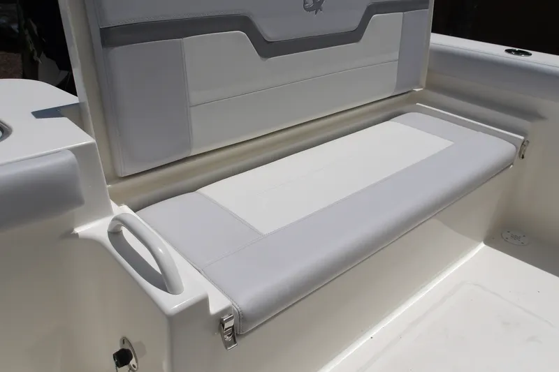 Slide: The Image of 2027 Mako 226 Center Console boat seat with white and gray upholstery. - 17