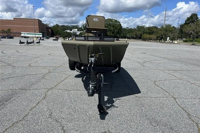 Slide: The Image of 2027 Tracker Grizzly 1650 T Prairie Wings Edition boat on trailer in parking lot. - 41