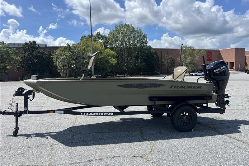 The Image of 2027 Tracker Grizzly 1650 T Prairie Wings Edition boat on trailer in parking lot. - 0