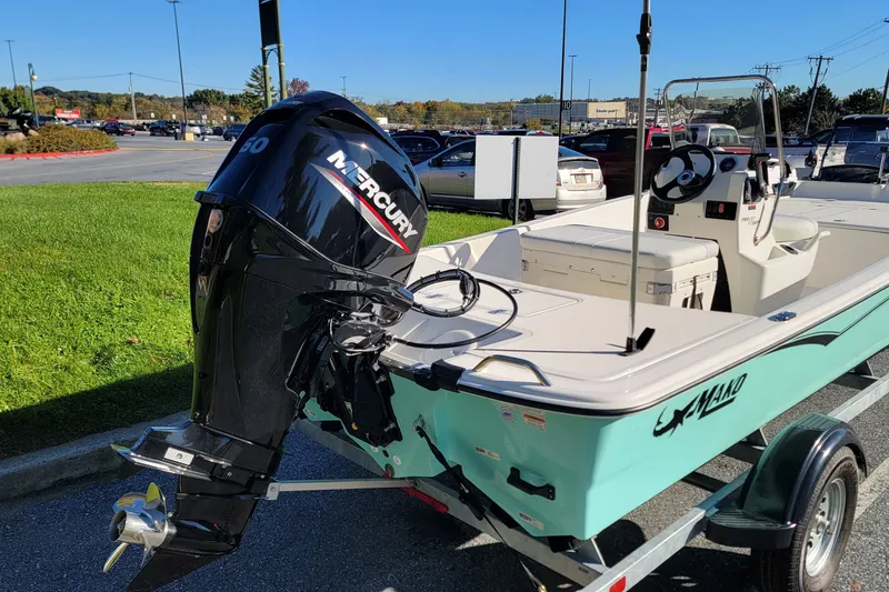 Slide: The Image of 2027 Mako Pro Skiff 17 CC boat with Mercury engine on trailer in parking lot. - 5
