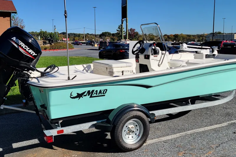Slide: The Image of 2027 Mako Pro Skiff 17 CC boat on trailer with Mercury outboard motor. - 3