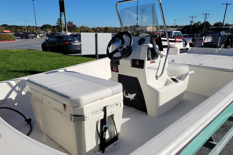 Slide: The Image of 2027 Mako Pro Skiff 17 CC boat interior with steering console and seating. - 4