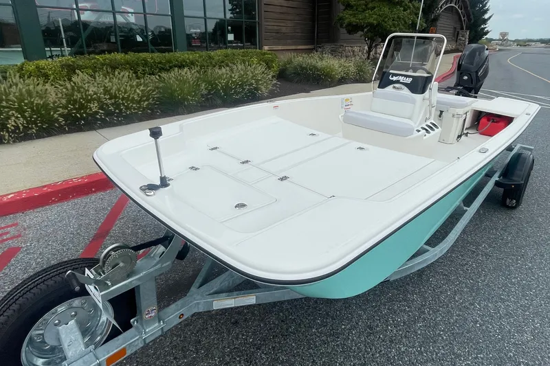 Slide: The Image of 2027 Mako Pro Skiff 17 CC boat on trailer, parked outdoors. - 1