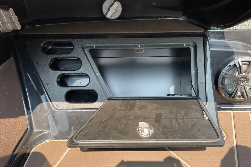 Slide: The Image of Storage compartment and speaker in 2027 Nitro Z19 XL boat interior. - 26