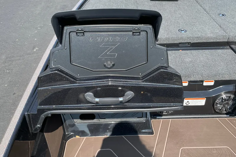 Slide: The Image of 2027 Nitro Z19 XL boat storage compartment with handle and carpeted deck. - 15