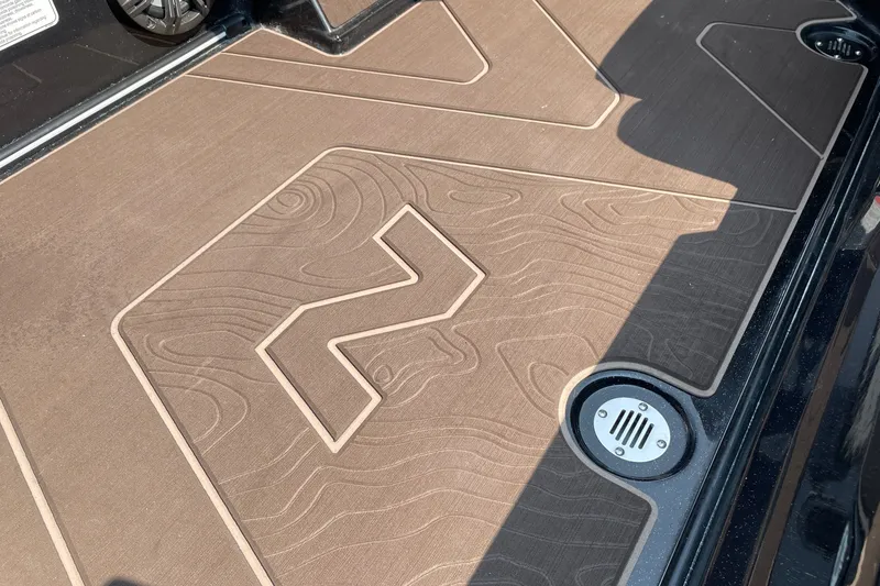 Slide: The Image of Flooring detail of a 2027 Nitro Z19 XL boat with textured design and drain. - 27