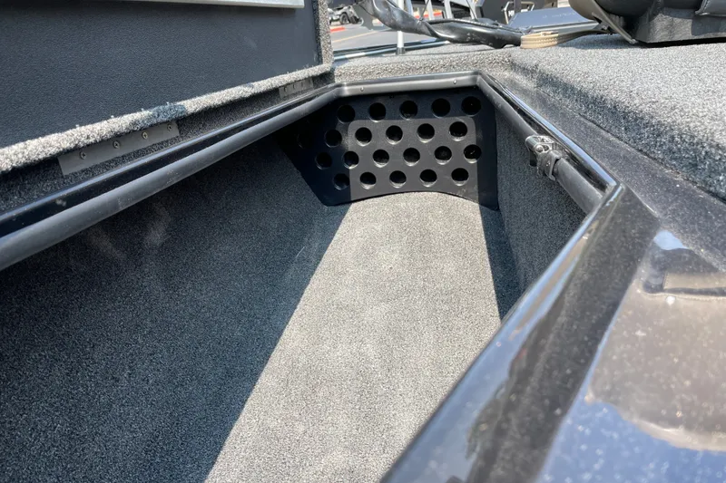 Slide: The Image of Interior storage compartment of 2027 Nitro Z19 XL boat, featuring carpeted finish and ventilation holes. - 30
