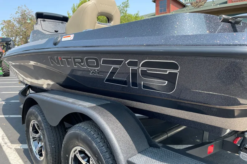 Slide: The Image of 2027 Nitro Z19 XL boat on trailer, showcasing sleek design and branding. - 38