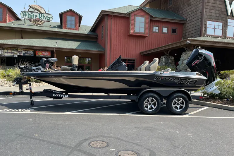 Slide: The Image of 2027 Nitro Z19 XL boat parked outside a rustic building. - 4