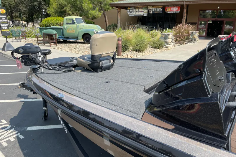 Slide: The Image of 2027 Nitro Z19 XL boat parked outside a store with vintage truck in background. - 10