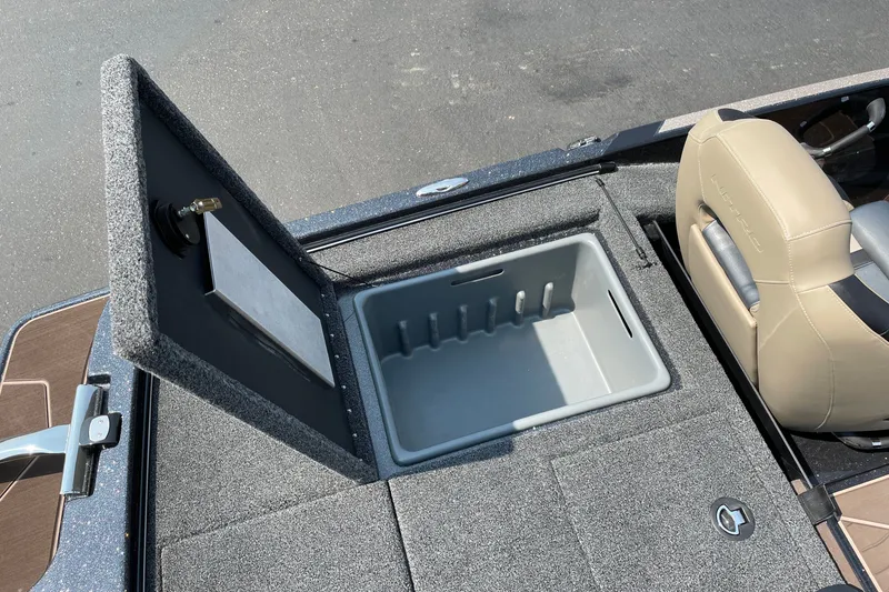 Slide: The Image of 2027 Nitro Z19 XL boat storage compartment with open lid and beige seating. - 20