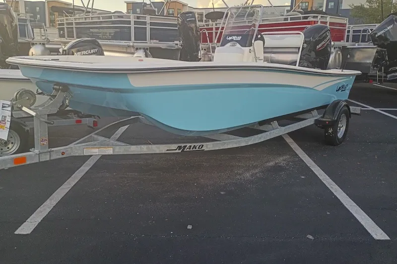 The Image of 2027 Mako Pro Skiff 17 CC boat on trailer, displayed in a parking lot. - 0