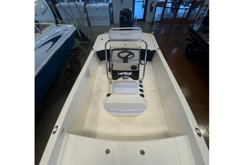 Slide: The Image of 2027 Mako Pro Skiff 17 CC boat interior, featuring center console and seating. - 9