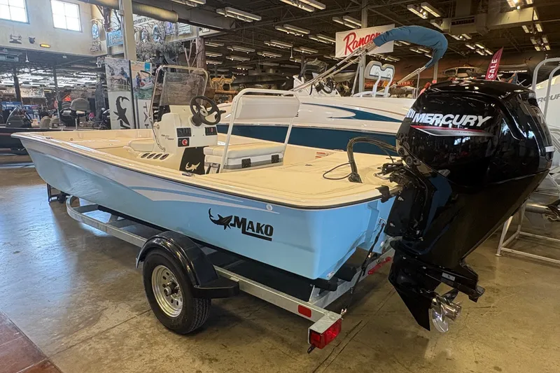 Slide: The Image of 2027 Mako Pro Skiff 17 CC boat with Mercury engine on display in showroom. - 5