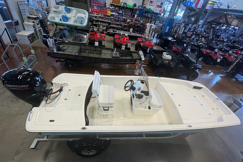 Slide: The Image of 2027 Mako Pro Skiff 17 CC boat displayed indoors, featuring a Mercury engine. - 11