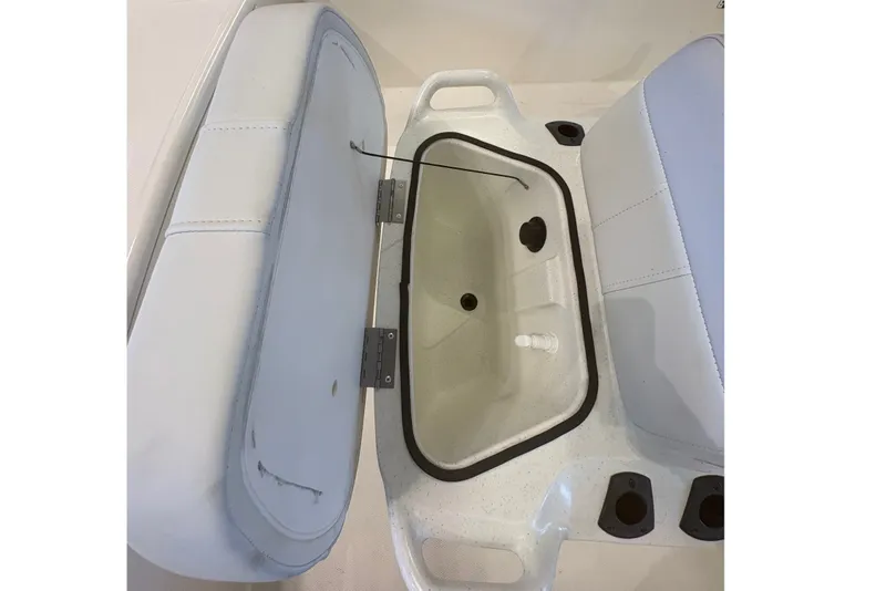 Slide: The Image of 2027 Mako Pro Skiff 17 CC boat interior with open storage compartment and seating. - 20