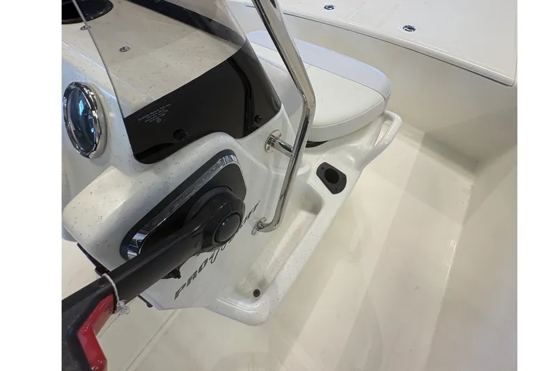 Slide: The Image of 2027 Mako Pro Skiff 17 CC boat interior with steering console and seating. - 18