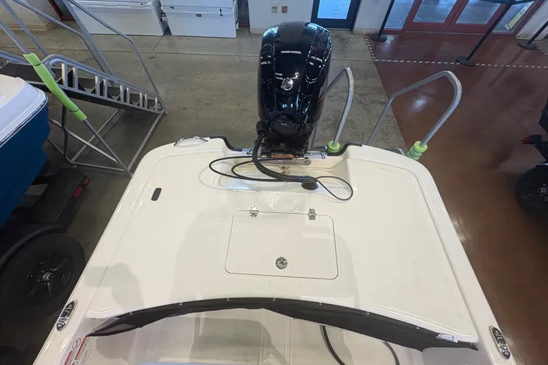 Slide: The Image of 2027 Mako Pro Skiff 17 CC boat with outboard motor in showroom. - 64