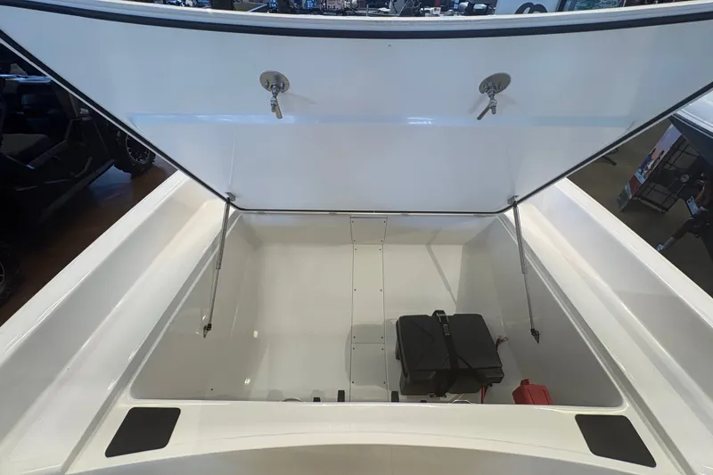 Slide: The Image of Open storage compartment of 2027 Mako Pro Skiff 17 CC boat, showcasing interior space. - 65