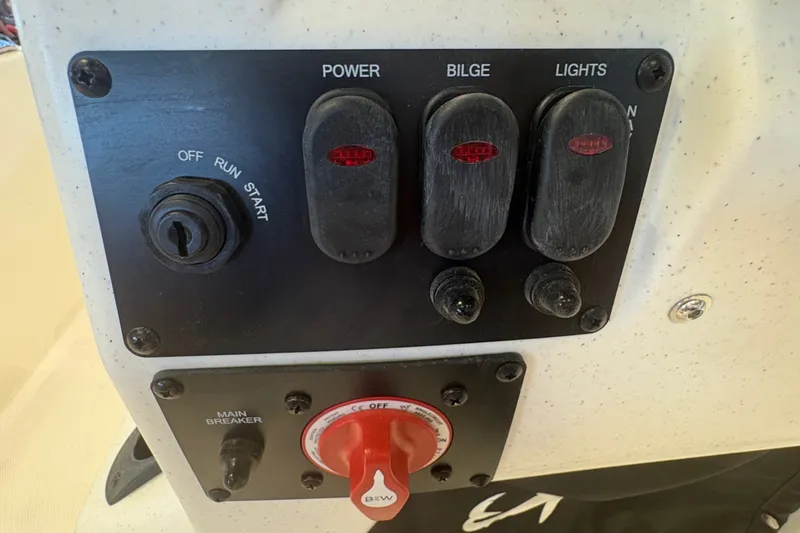 Slide: The Image of Control panel of 2027 Mako Pro Skiff 17 CC boat with switches and ignition. - 13