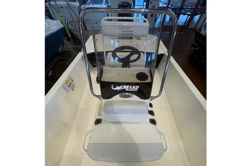 Slide: The Image of 2027 Mako Pro Skiff 17 CC boat interior with steering console and seating. - 8
