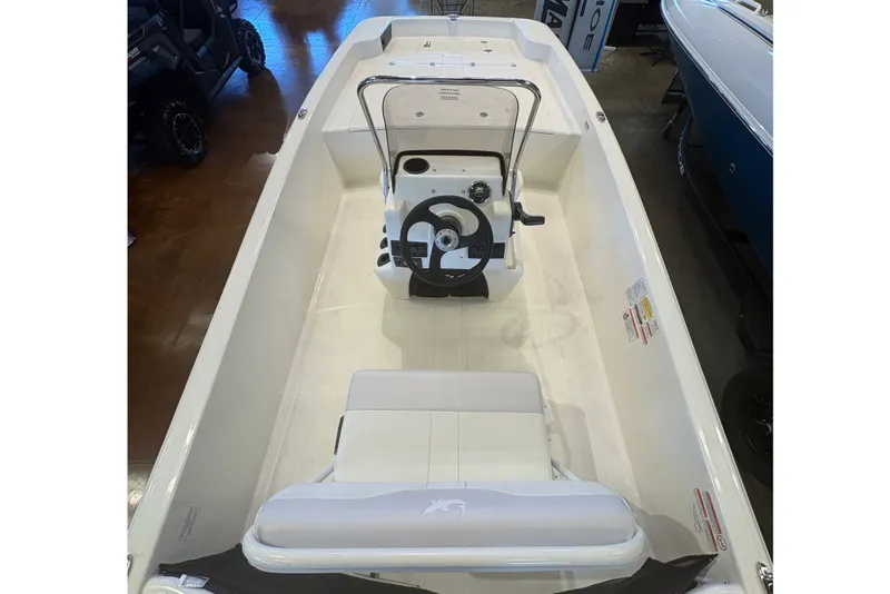 Slide: The Image of 2027 Mako Pro Skiff 17 CC boat interior, featuring center console and seating. - 10