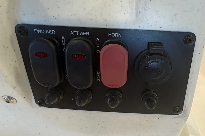 Slide: The Image of Control panel on 2027 Mako Pro Skiff 17 CC boat with switches and horn. - 12