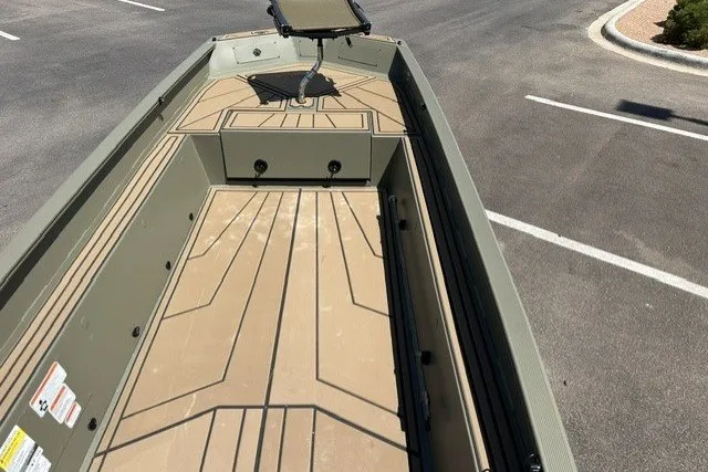 Slide: The Image of 2027 Tracker Grizzly 1650 T Prairie Wings Edition boat interior with tan deck design. - 14
