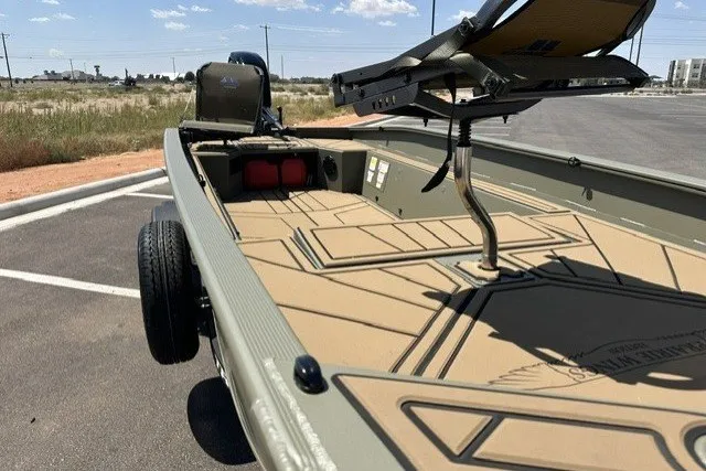 Slide: The Image of 2027 Tracker Grizzly 1650 T Prairie Wings Edition boat in parking lot, showcasing interior and seating. - 13