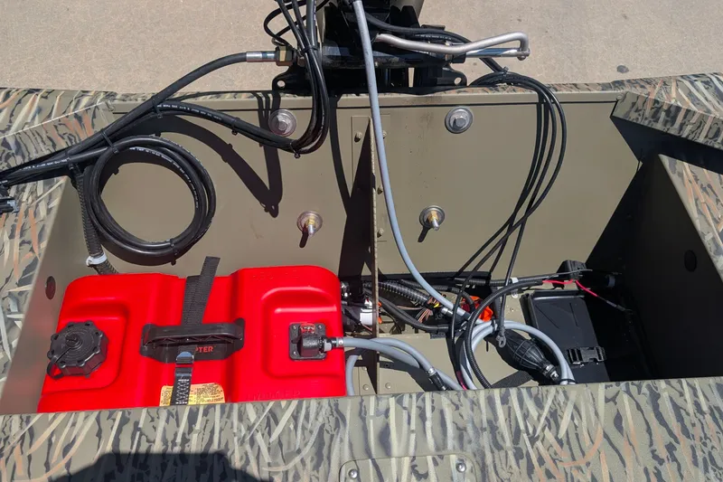 Slide: The Image of 2027 Tracker Grizzly 1648 SC boat interior showing fuel tank and wiring setup. - 13