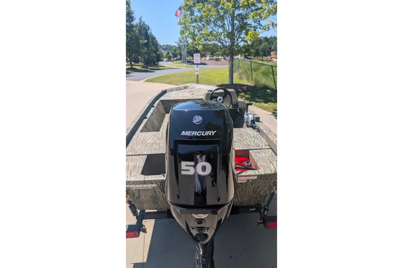 Slide: The Image of 2027 Tracker Grizzly 1648 SC boat with Mercury 50 engine, parked outdoors. - 15