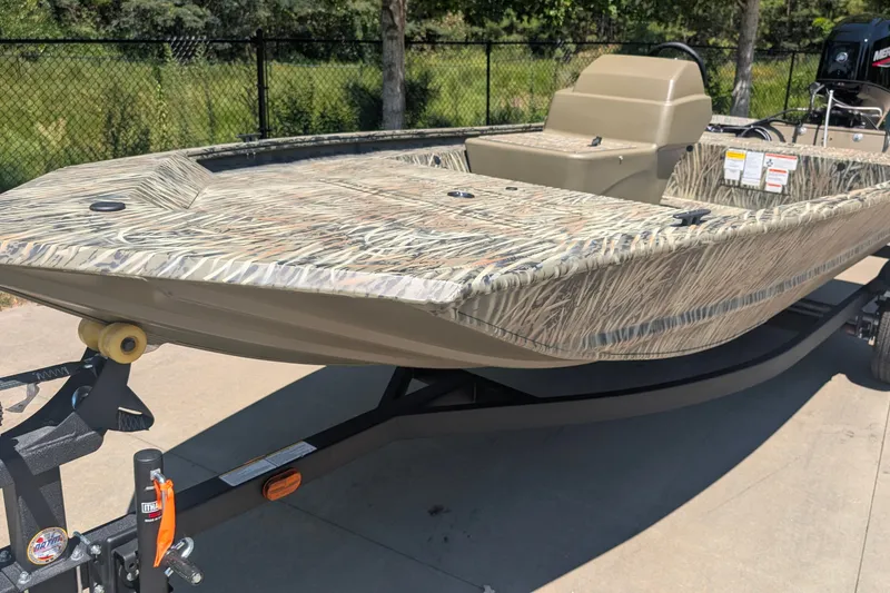 The Image of 2027 Tracker Grizzly 1648 SC boat with camouflage design on a trailer. - 0