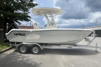 Slide: The Image of 2027 Mako 226 Center Console boat on trailer, parked outdoors under cloudy sky. - 4