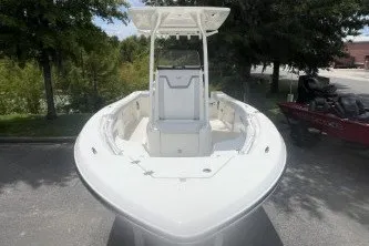 Slide: The Image of 2027 Mako 226 Center Console boat, white, parked outdoors, front view. - 2