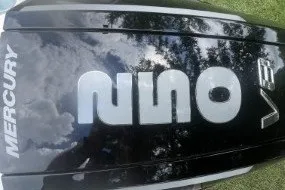 Slide: The Image of Mercury outboard engine cover reflecting sky and trees, Mako 226 Center Console 2027. - 6