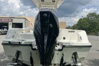 Slide: The Image of 2027 Mako 226 Center Console boat with powerful outboard motor, parked outdoors. - 3