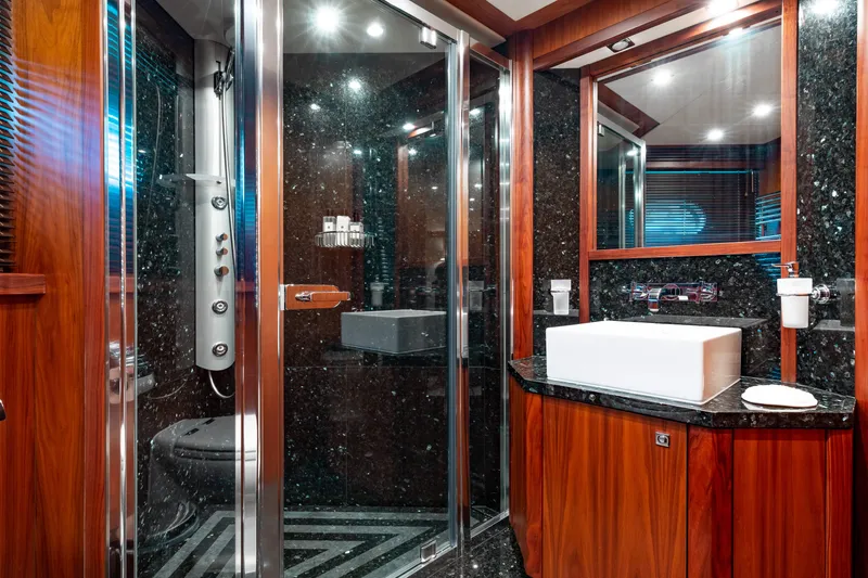 Slide: The Image of Luxurious bathroom in a 2009 Sunseeker 121 yacht with modern fixtures and wood accents. - 22
